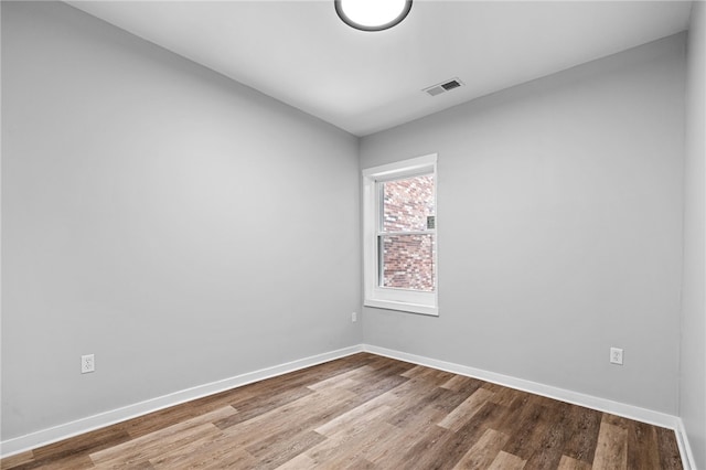 empty room with hardwood / wood-style flooring