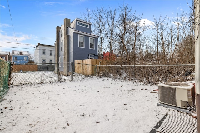 yard layered in snow featuring cooling unit