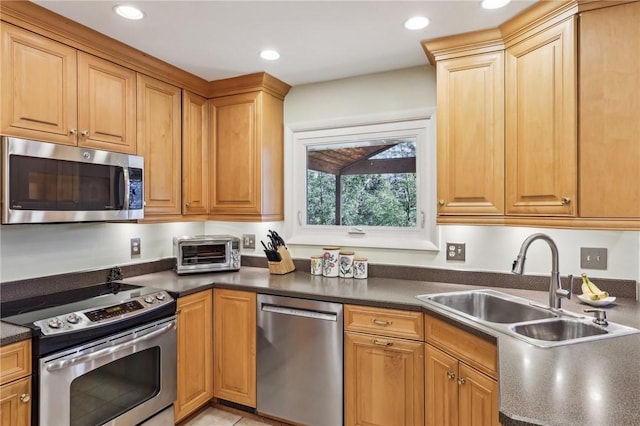 kitchen with sink and appliances with stainless steel finishes