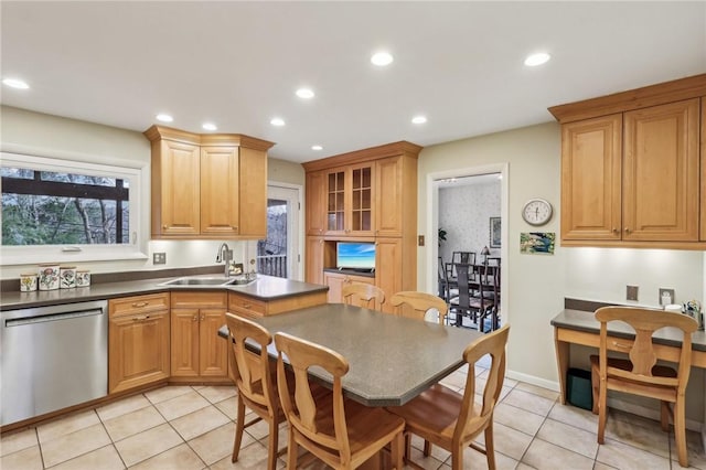 kitchen featuring dishwasher, light tile patterned floors, and sink