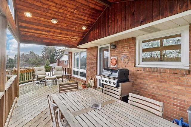 wooden terrace featuring a grill and a sunroom