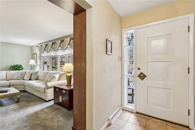 entrance foyer with baseboard heating and light tile patterned floors