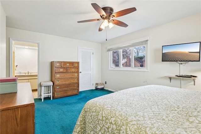 carpeted bedroom with a closet, ceiling fan, and sink