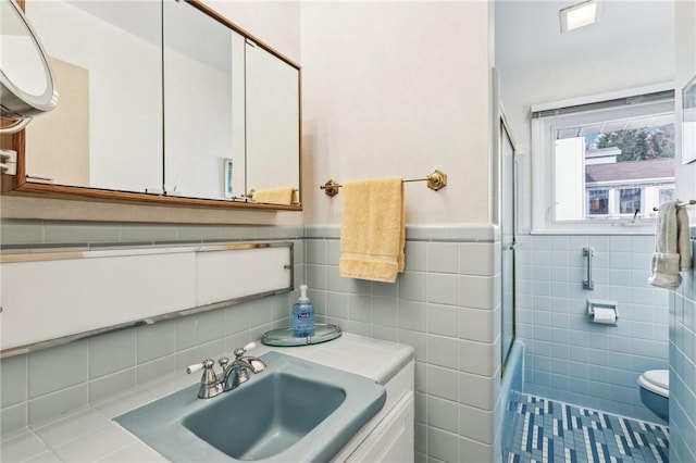 bathroom featuring tile patterned flooring, vanity, and tile walls