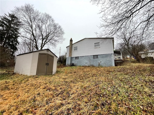 view of side of property featuring central AC and a storage unit