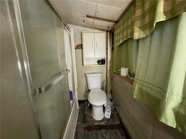 bathroom with toilet and walk in shower