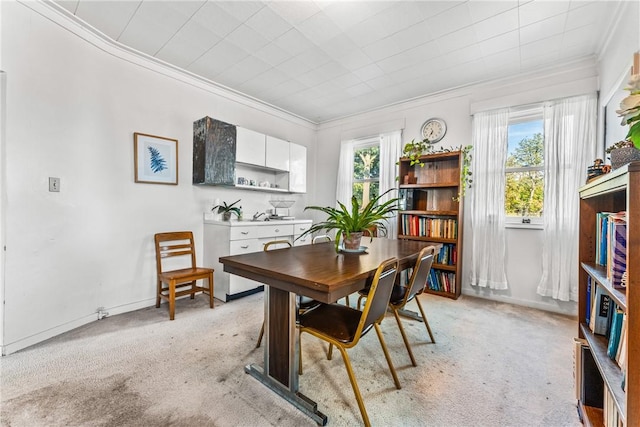 carpeted dining area featuring a healthy amount of sunlight and crown molding