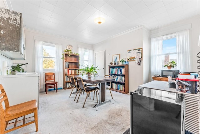 dining area with light carpet and crown molding