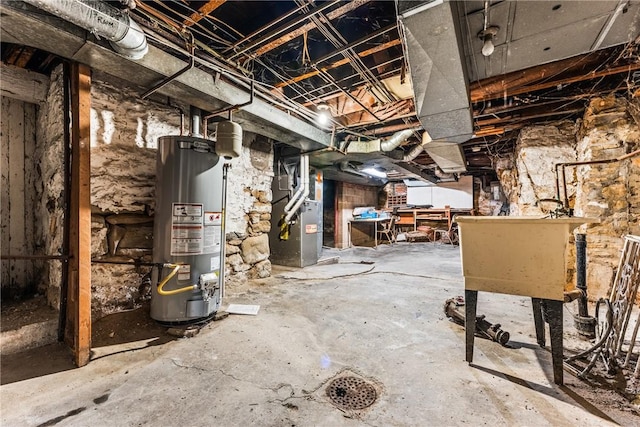 basement featuring gas water heater and heating unit