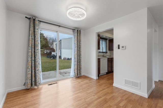 empty room featuring light hardwood / wood-style flooring and sink