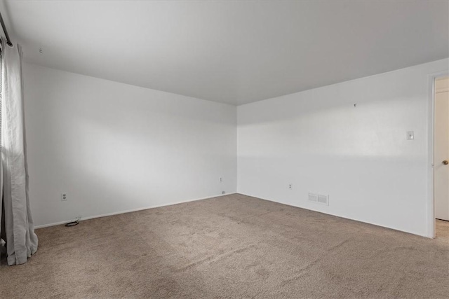 empty room featuring light colored carpet