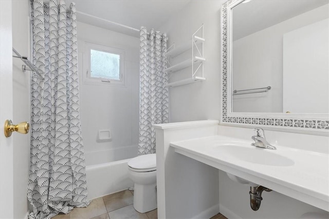 bathroom with tile patterned flooring, shower / bath combo, and toilet