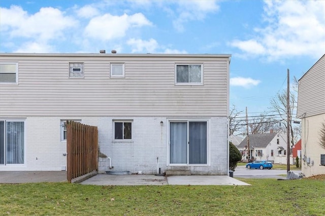 rear view of house featuring a yard