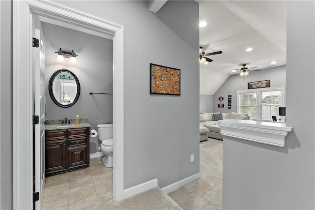 bathroom featuring vanity, lofted ceiling, ceiling fan, and toilet