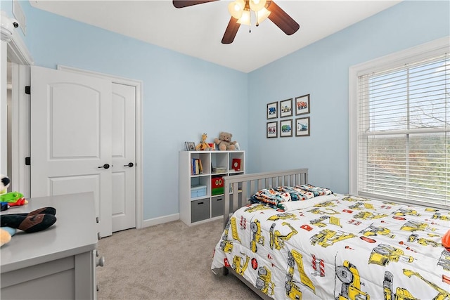 carpeted bedroom featuring a closet and ceiling fan