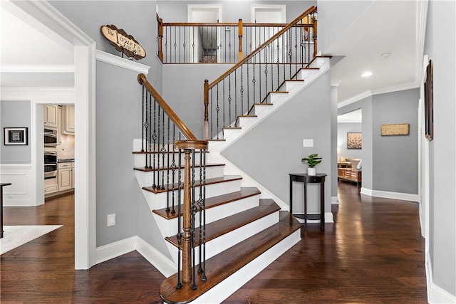 staircase featuring hardwood / wood-style flooring and ornamental molding