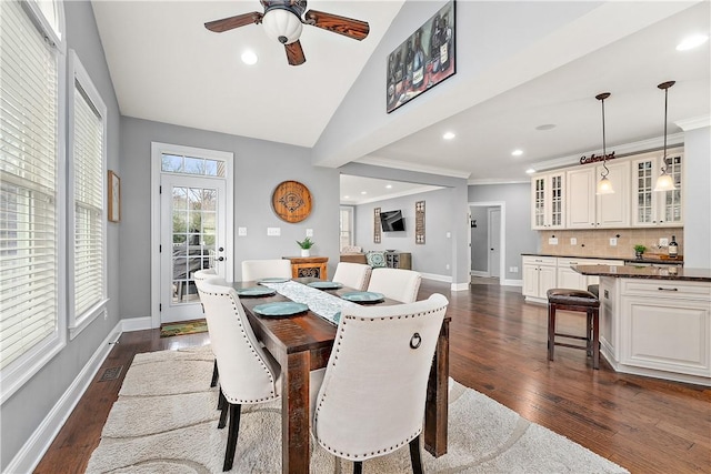 dining room featuring dark wood-type flooring, ceiling fan, and lofted ceiling