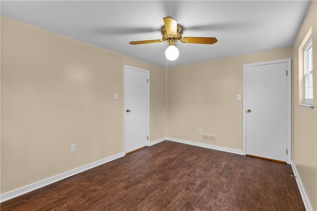 empty room featuring dark hardwood / wood-style floors and ceiling fan