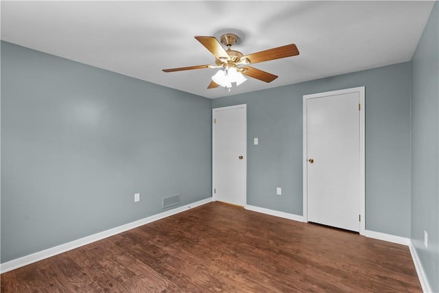 unfurnished bedroom with ceiling fan and dark hardwood / wood-style flooring