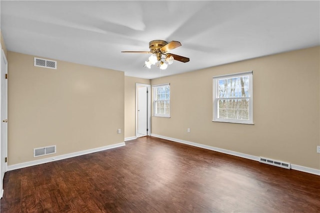 spare room with ceiling fan and dark wood-type flooring