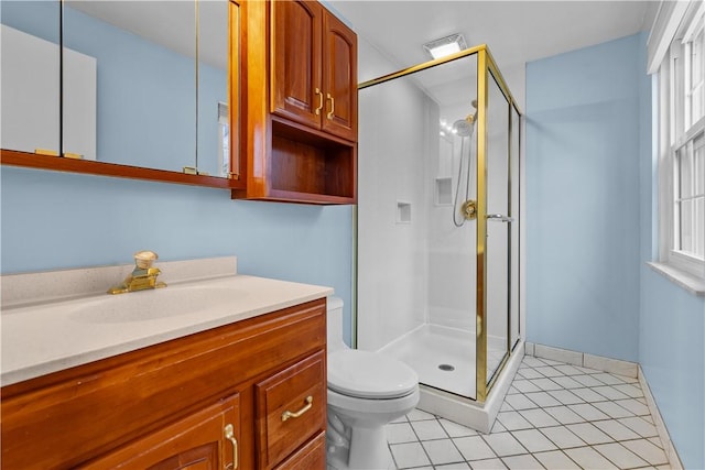 bathroom featuring tile patterned floors, vanity, an enclosed shower, and toilet