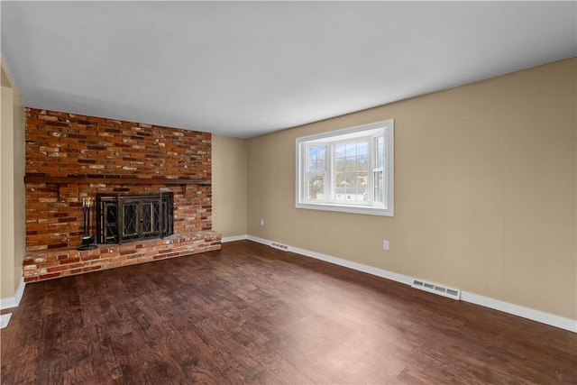 unfurnished living room with a fireplace and hardwood / wood-style flooring