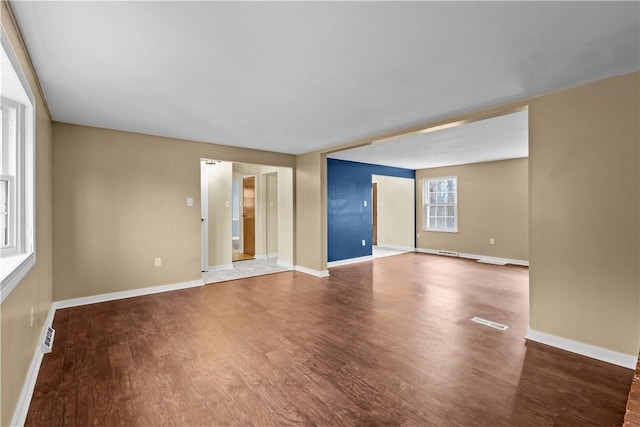 empty room featuring dark hardwood / wood-style floors and plenty of natural light