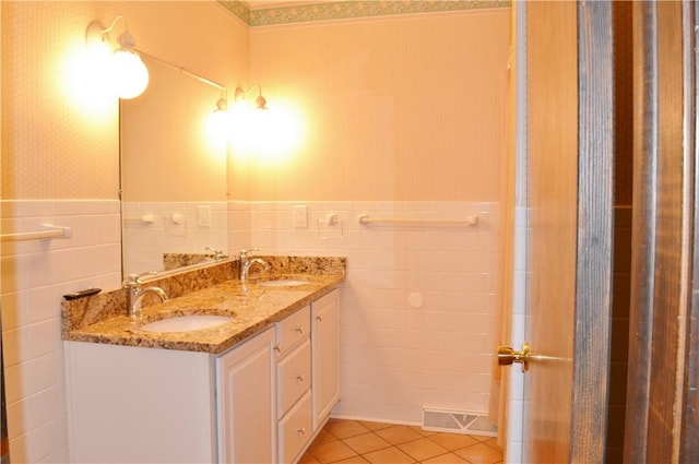 bathroom with tile patterned floors, vanity, and tile walls