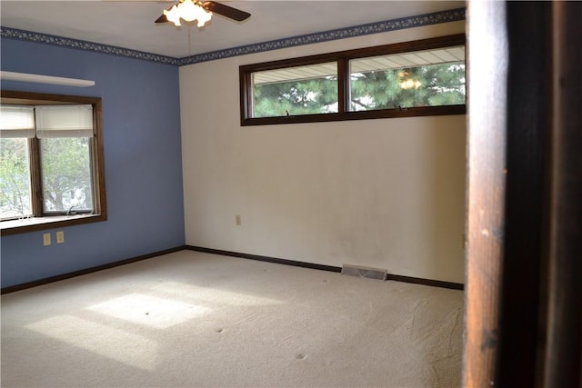 spare room featuring carpet and ceiling fan