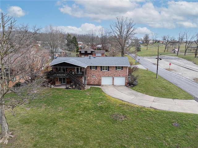 view of front facade with a wooden deck, a front yard, and a garage