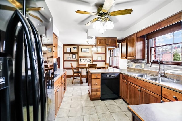 kitchen featuring kitchen peninsula, backsplash, sink, black appliances, and light tile patterned floors