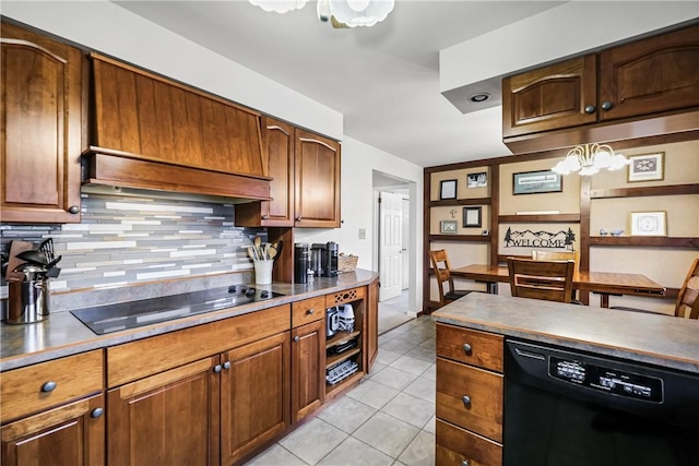 kitchen with black appliances, tasteful backsplash, light tile patterned flooring, custom range hood, and a chandelier