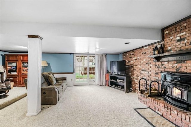 carpeted living room with a wood stove