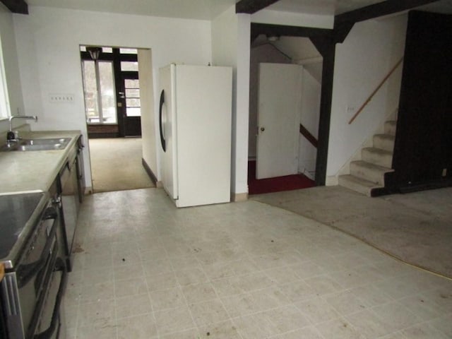 kitchen featuring french doors, white refrigerator, black electric range oven, and sink