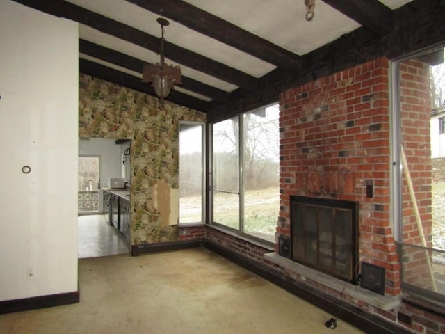 unfurnished sunroom featuring vaulted ceiling with beams and a fireplace