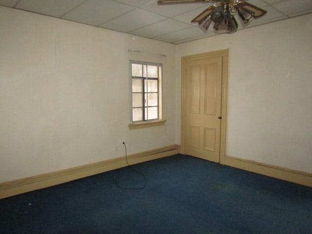 unfurnished room with carpet, ceiling fan, and a paneled ceiling