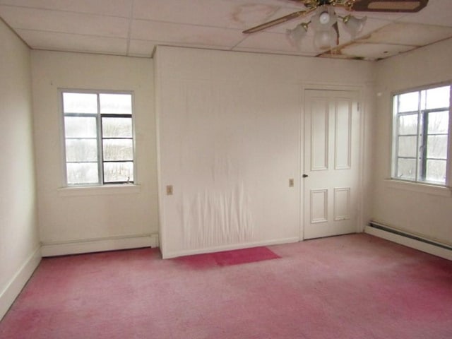 unfurnished room with a paneled ceiling, ceiling fan, carpet floors, and a baseboard heating unit