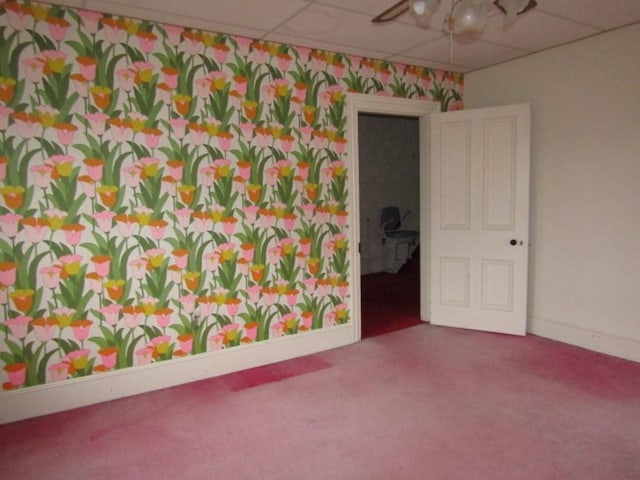 unfurnished room featuring carpet floors and a drop ceiling