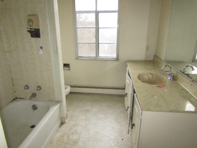 bathroom with baseboard heating, a wealth of natural light, vanity, and toilet