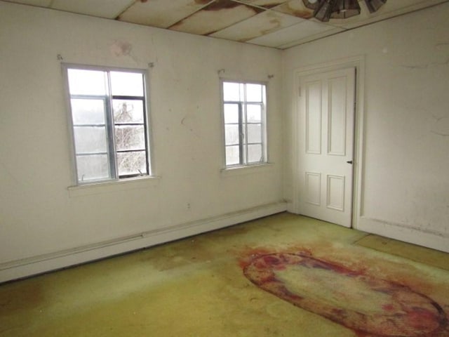 unfurnished room with baseboard heating