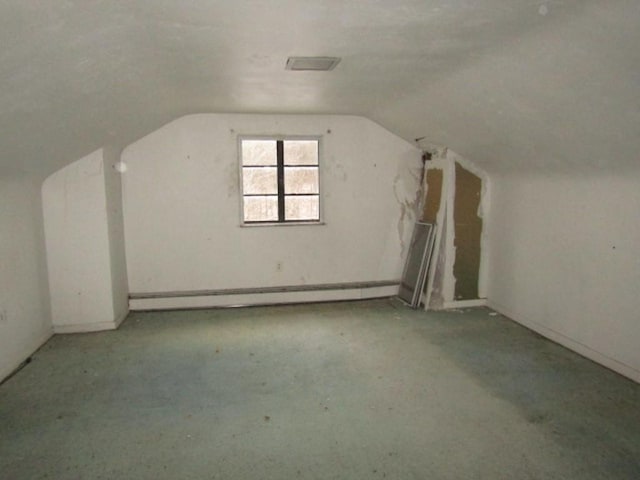 bonus room featuring lofted ceiling and a baseboard heating unit