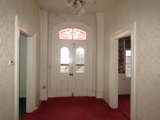 foyer featuring ceiling fan and french doors