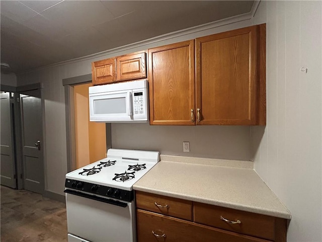 kitchen featuring crown molding and white appliances