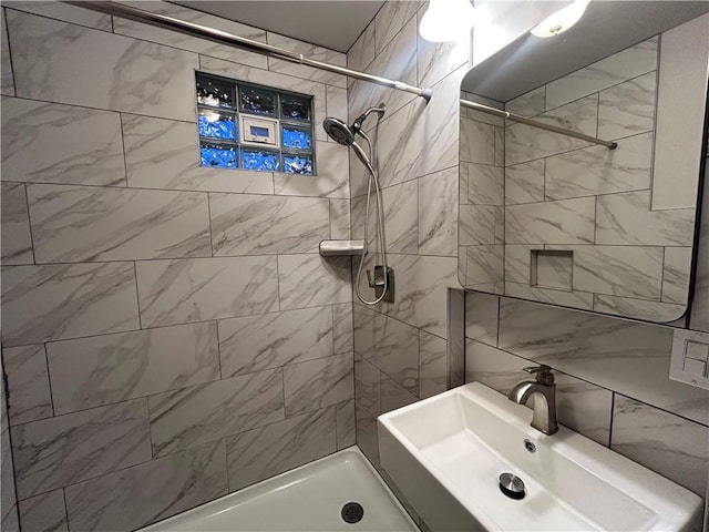 bathroom with sink and tiled shower