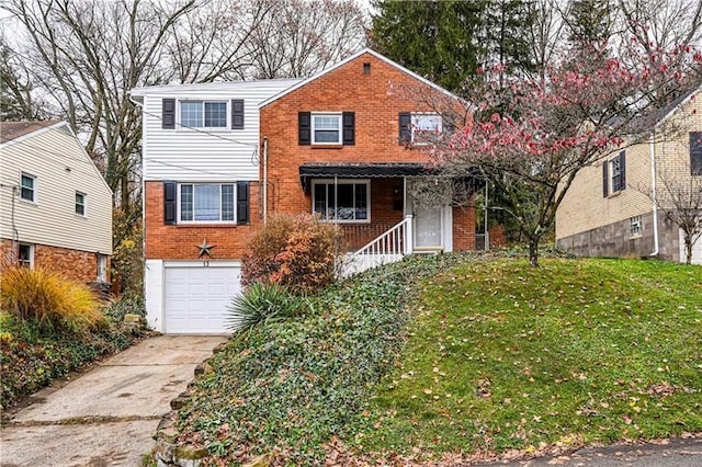 front of property featuring a front lawn, covered porch, and a garage