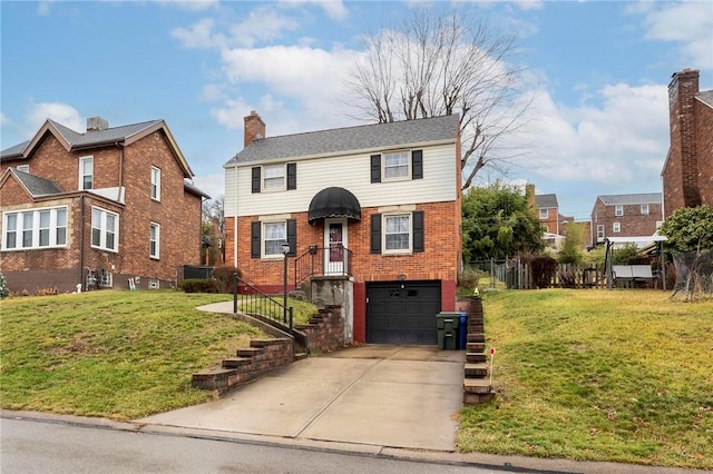 view of property featuring a front yard and a garage