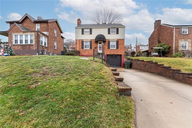 front of property with a front lawn and a garage