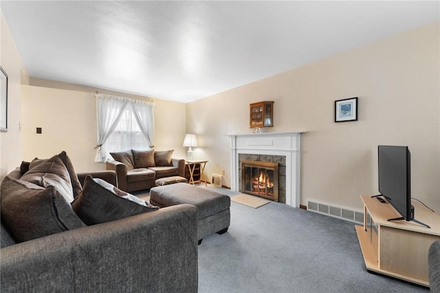 living room with a premium fireplace and carpet floors