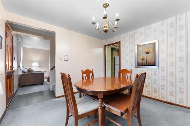 carpeted dining room with a notable chandelier