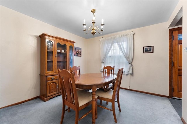 dining area with light carpet and an inviting chandelier